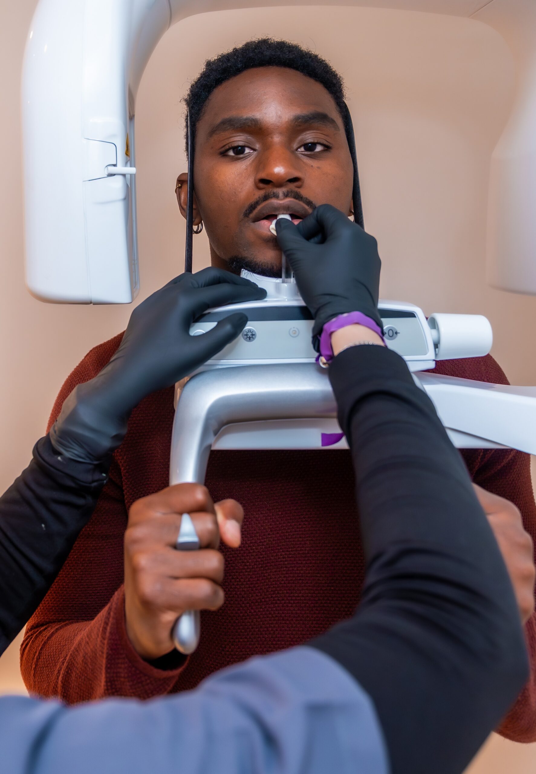 Dentist positioning patient for dental x ray scan in modern clinic