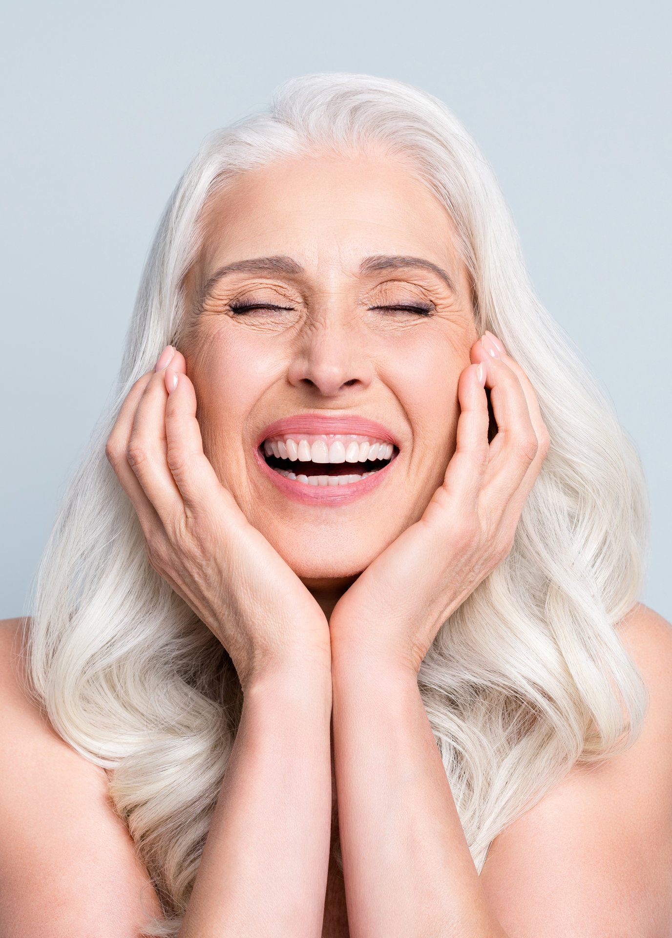 Close-up portrait of her she nice attractive excited cheerful grey-haired elderly lady touching cheeks laughing isolated gray pastel color background
